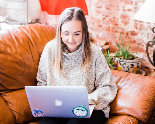 Student on her laptop while sitting on a couch